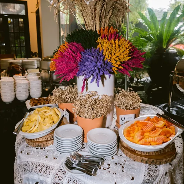 The Fiesta sa Cabel buffet table with dishes, stacked plates and a tall arrangement of dried flowers